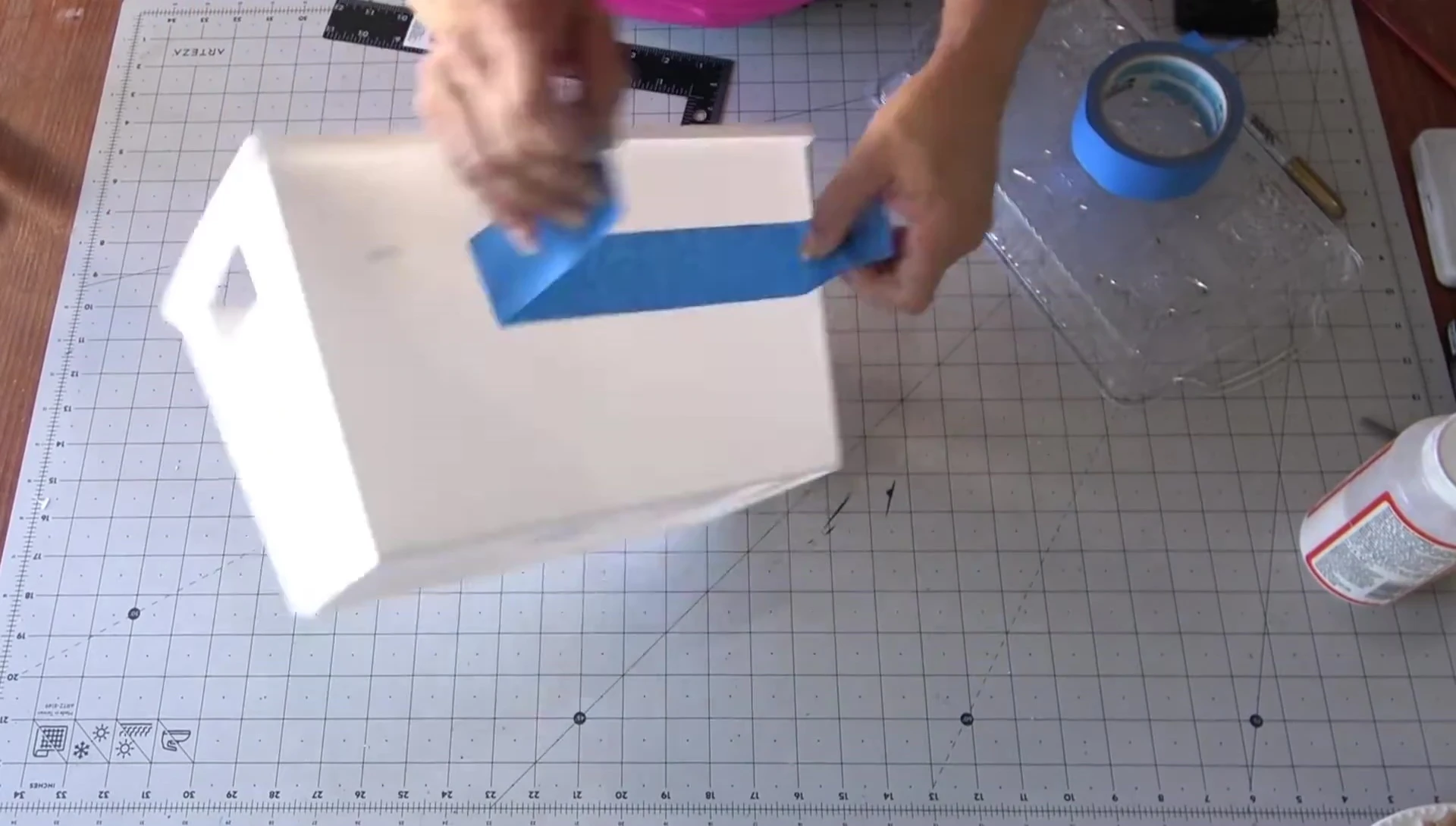 Applying painter's tape for clean cuts.