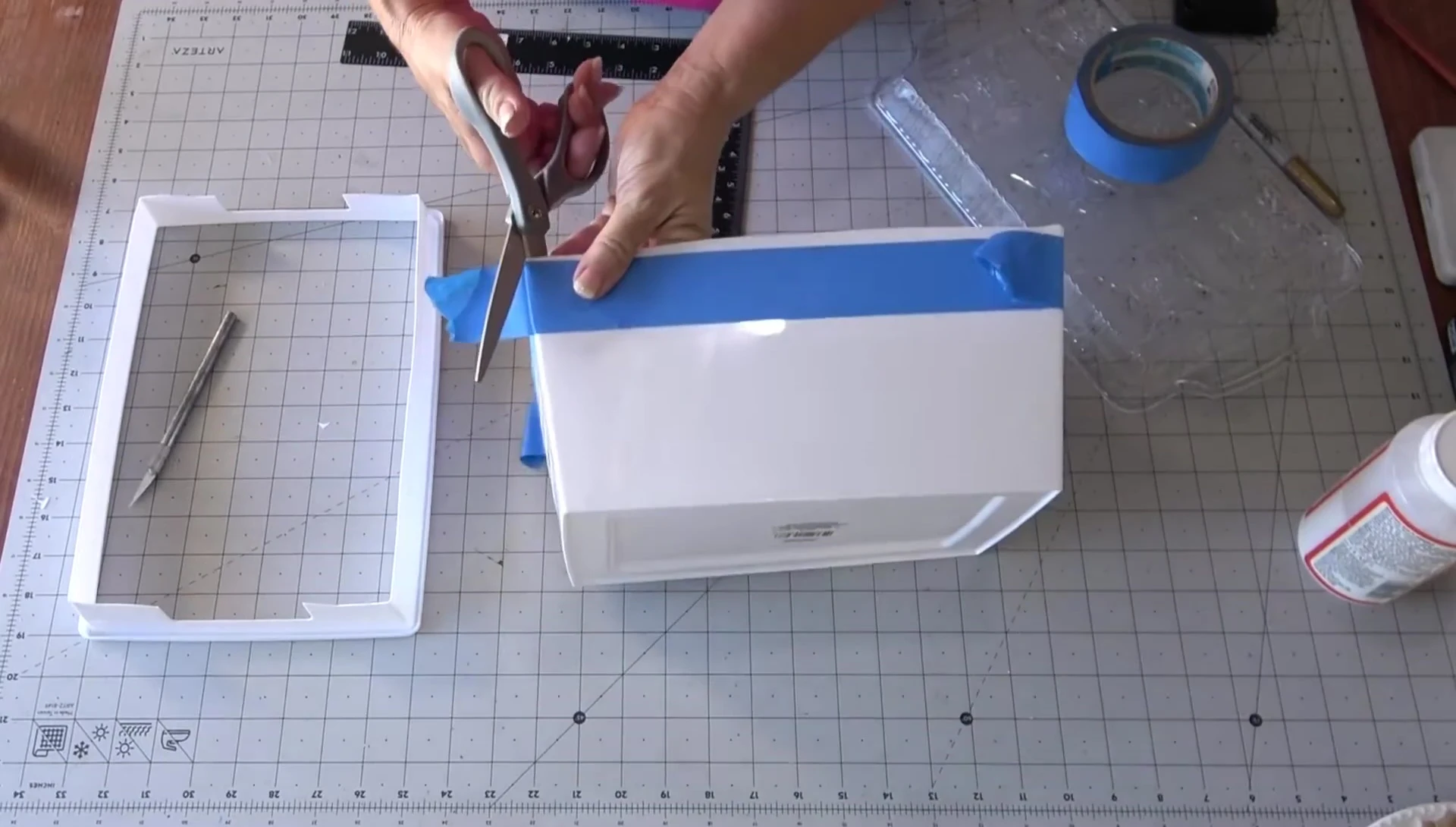 Trimming the cut edges with scissors.