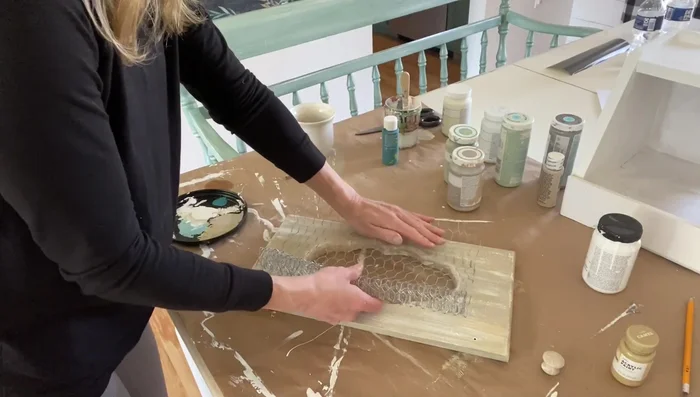 Cut and attach chicken wire to the inside of the bread box using a staple gun. Trim and curl sharp edges.