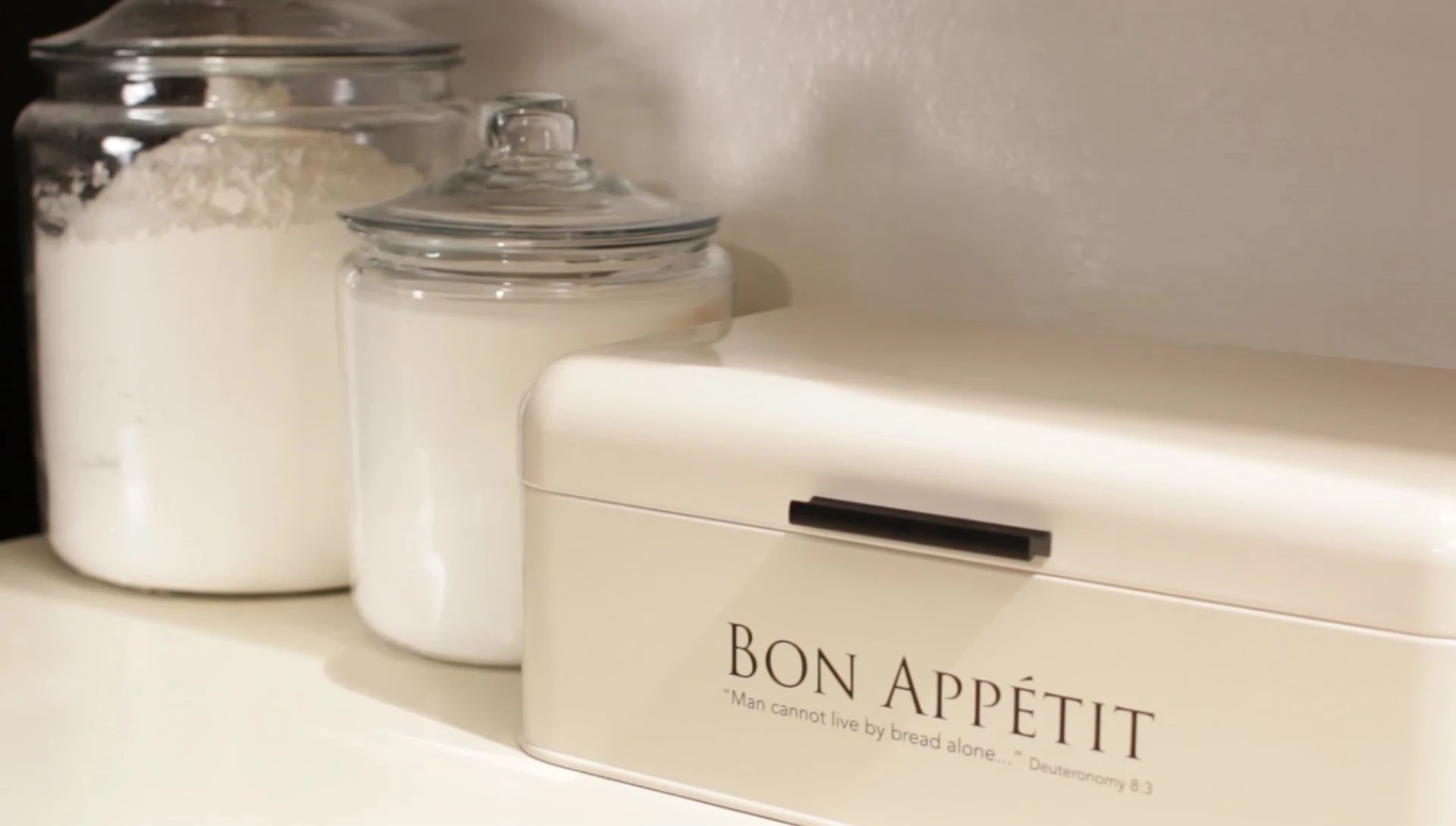 The bread box on the kitchen counter