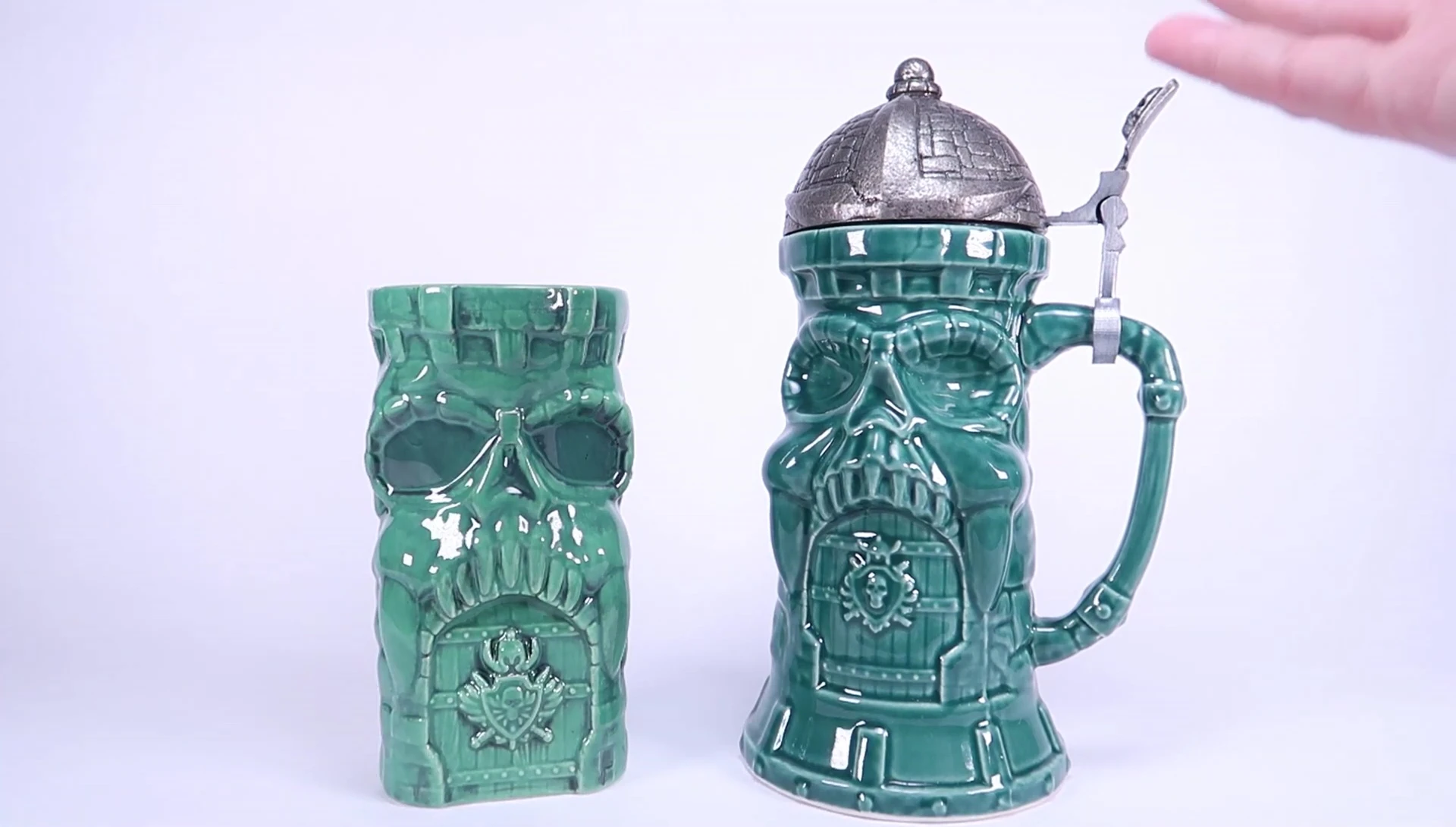 The tiki mug and beer stein displayed together, highlighting their height and size difference.