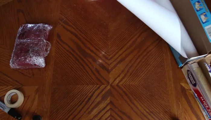 Fold the sides of the freezer paper inwards and tightly over the meat, creating a neat package.