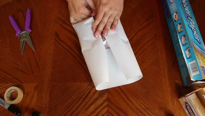 Fold the sides of the freezer paper inwards and tightly over the meat, creating a neat package.