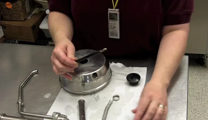 Place the stick inside, followed by the knob. Fold the bottom of the knob to allow screwing on the top.