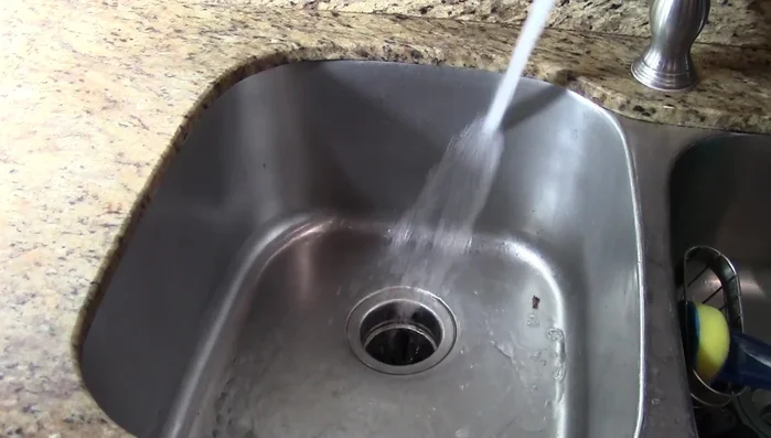 Run the garbage disposal for a couple of minutes to loosen debris.