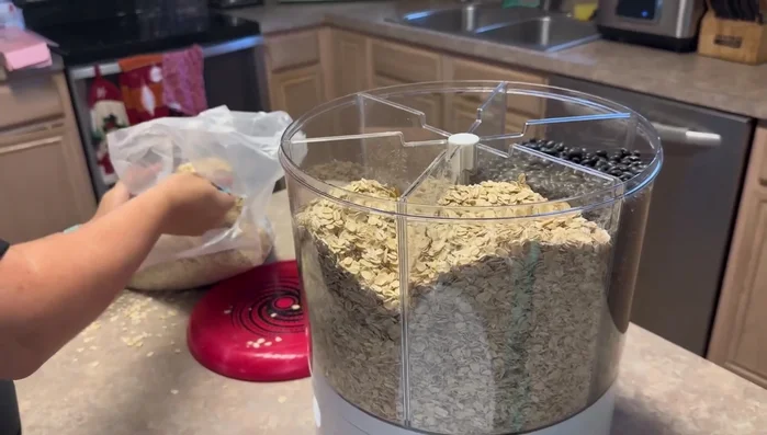 If the grain gets stuck at the bottom, use your finger to push it towards the dispensing mechanism.