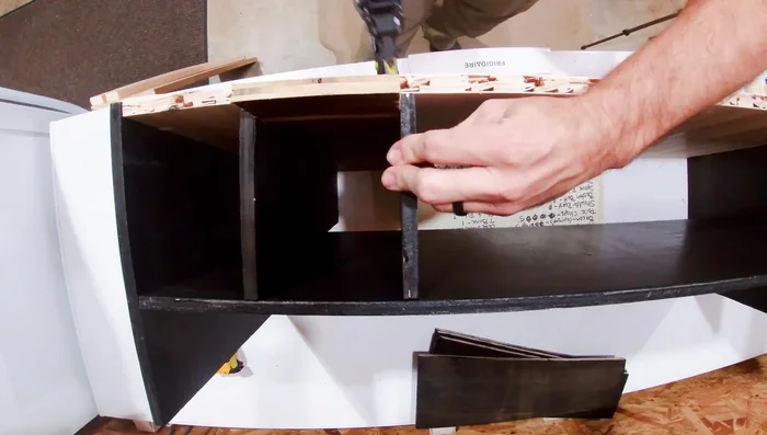 Attach the front piece. Accurate measurement is crucial to ensure the cans roll out smoothly.