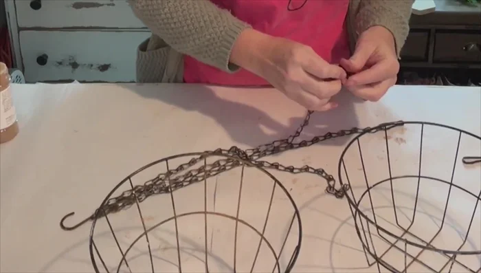 Separate seven links from the plant hanger chain using needle nose pliers.