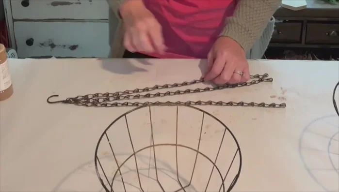 Separate seven links from the plant hanger chain using needle nose pliers.