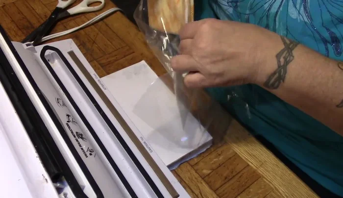 Straighten the bag and ensure the plastic edge is properly positioned.