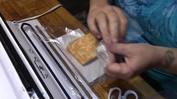 Fold the sealed side down, tucking the cut pieces in to coincide with the open bag edges.