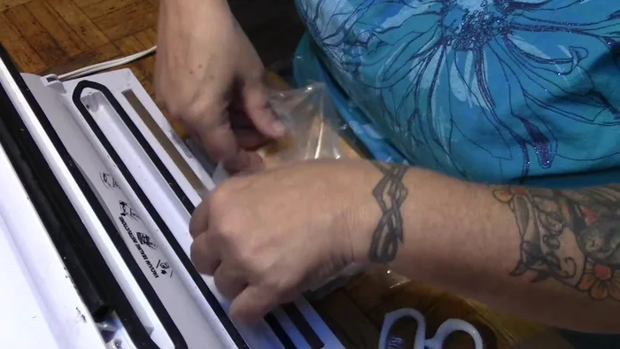 Fold the sealed side down, tucking the cut pieces in to coincide with the open bag edges.