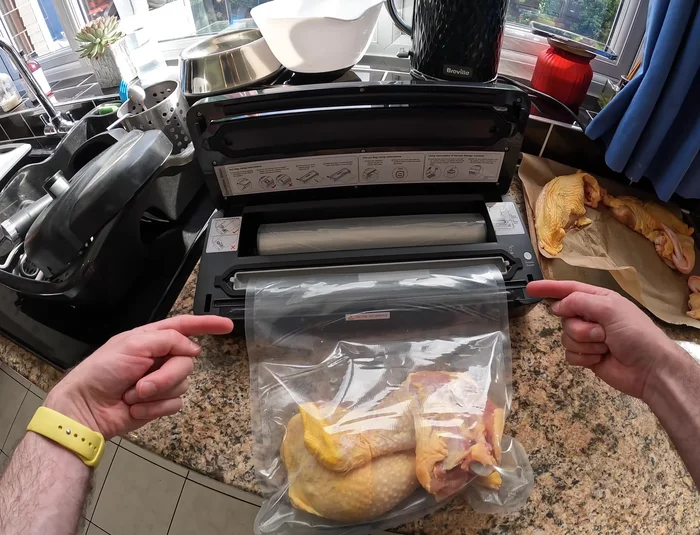 Place the bag into the vacuum sealer machine, ensuring the open end is facing the vacuum port.