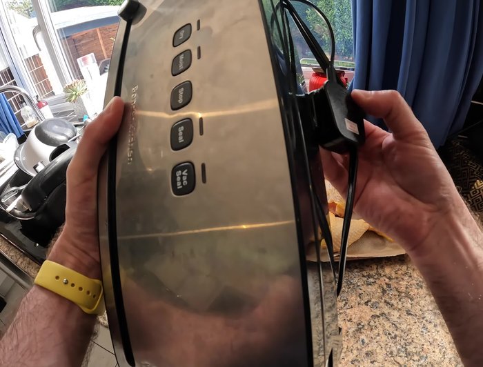 Prepare the vacuum sealer bag. Pull out a bag to the desired length, ensuring enough space between the food and the edge for a proper seal.