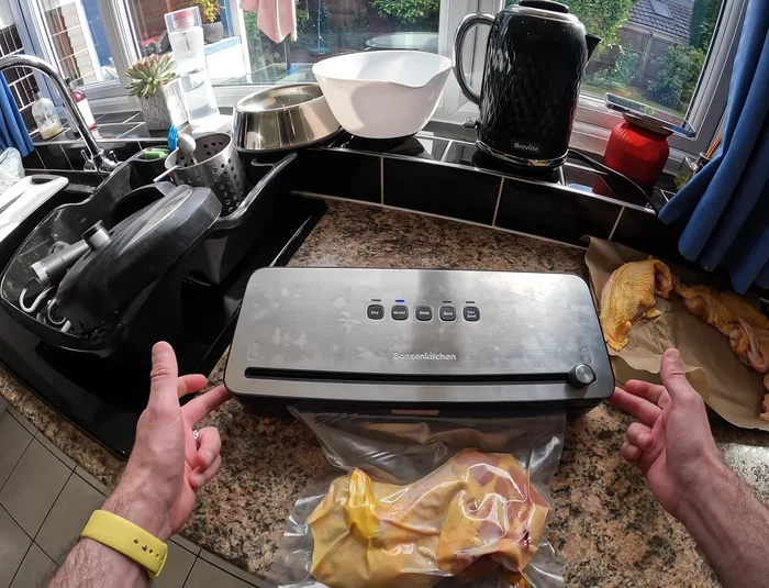 Once sealed, open the machine and remove the vacuum-sealed bag.