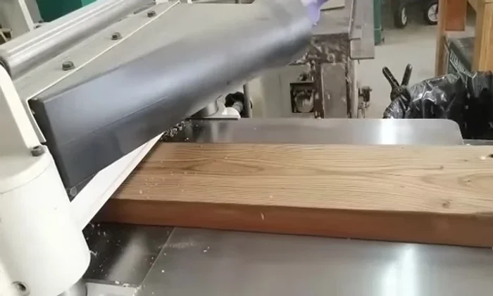 Seal and finish: Applying cutting board oil using a piece of fabric to seal and enhance the wood's appearance.
