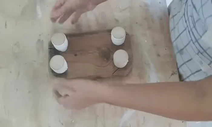 Seal and finish: Applying cutting board oil using a piece of fabric to seal and enhance the wood's appearance.