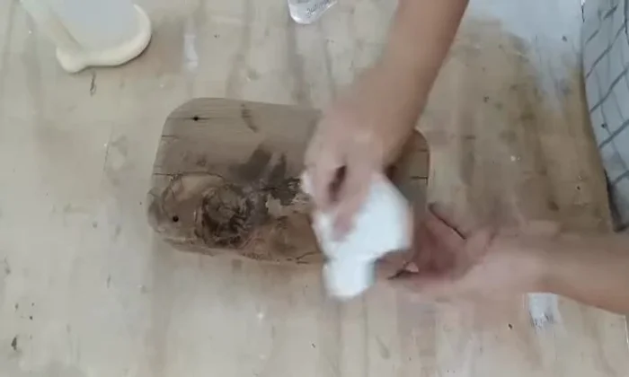 Seal and finish: Applying cutting board oil using a piece of fabric to seal and enhance the wood's appearance.