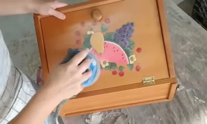 Distress the breadbox: Using an orbital sander to stress the edges and create a vintage look.