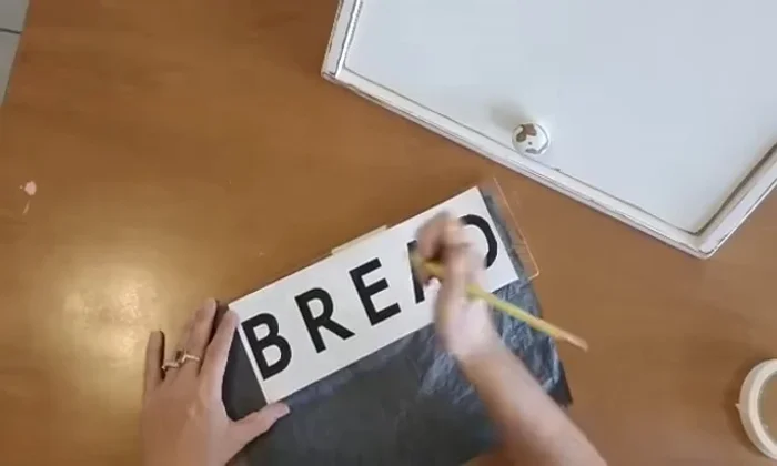 Distress the breadbox: Using an orbital sander to stress the edges and create a vintage look.