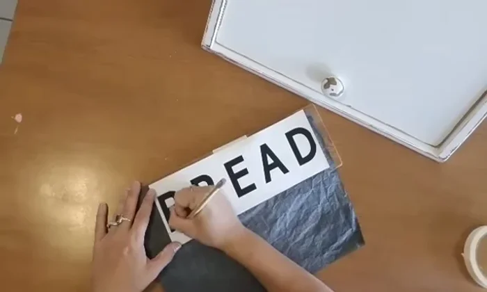 Attach label: Gluing and nailing on a braid label to the breadbox.