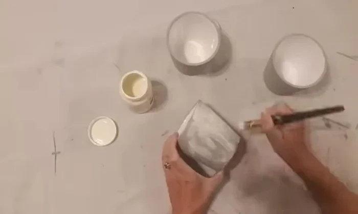 Wax the cups: Applying Waverly white wax and wiping it off with a dry cloth to create a textured, cement-like look.