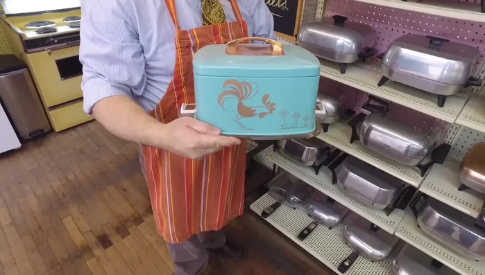 Showcase an aluminum cake carrier by Regal, noting its dual-purpose use for cakes and pies, and its resemblance to World War II ration containers.