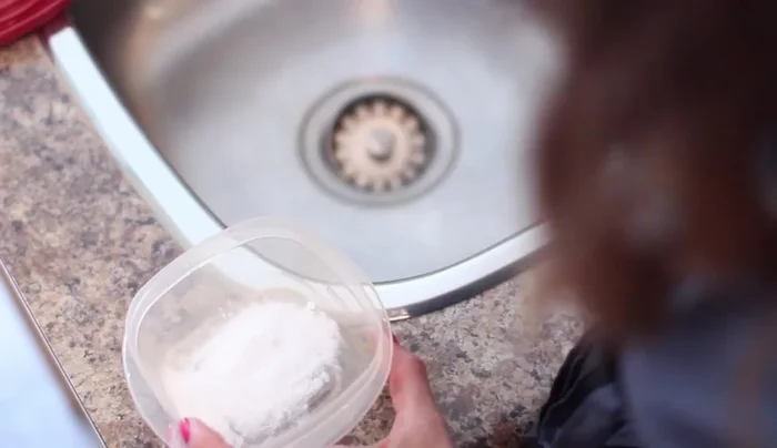 Empty the baking soda, rinse the container.