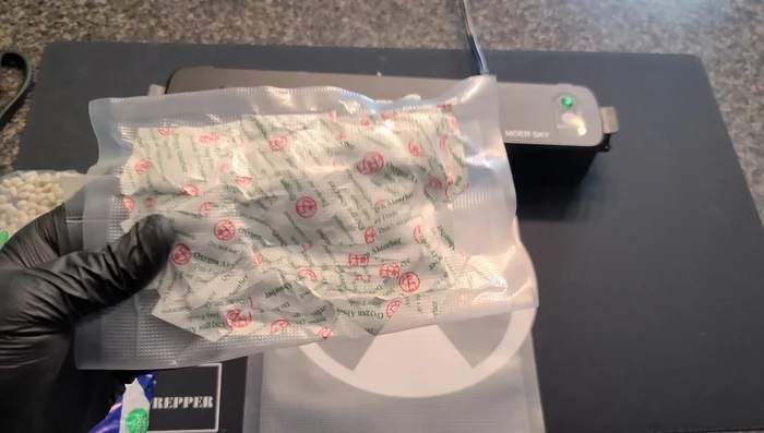 Add oxygen absorbers: Place one or more oxygen absorbers (or silica packets) into each bag. Work quickly after opening the absorber packet as they rapidly absorb oxygen and generate heat.