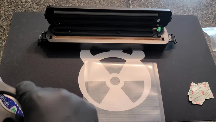 Vacuum seal the bags: Place the bag's textured side up into the vacuum sealer, ensuring the edge is properly positioned within the gasketed area. Close and activate the sealer, allowing it to fully remove air until the bag is rock-hard.