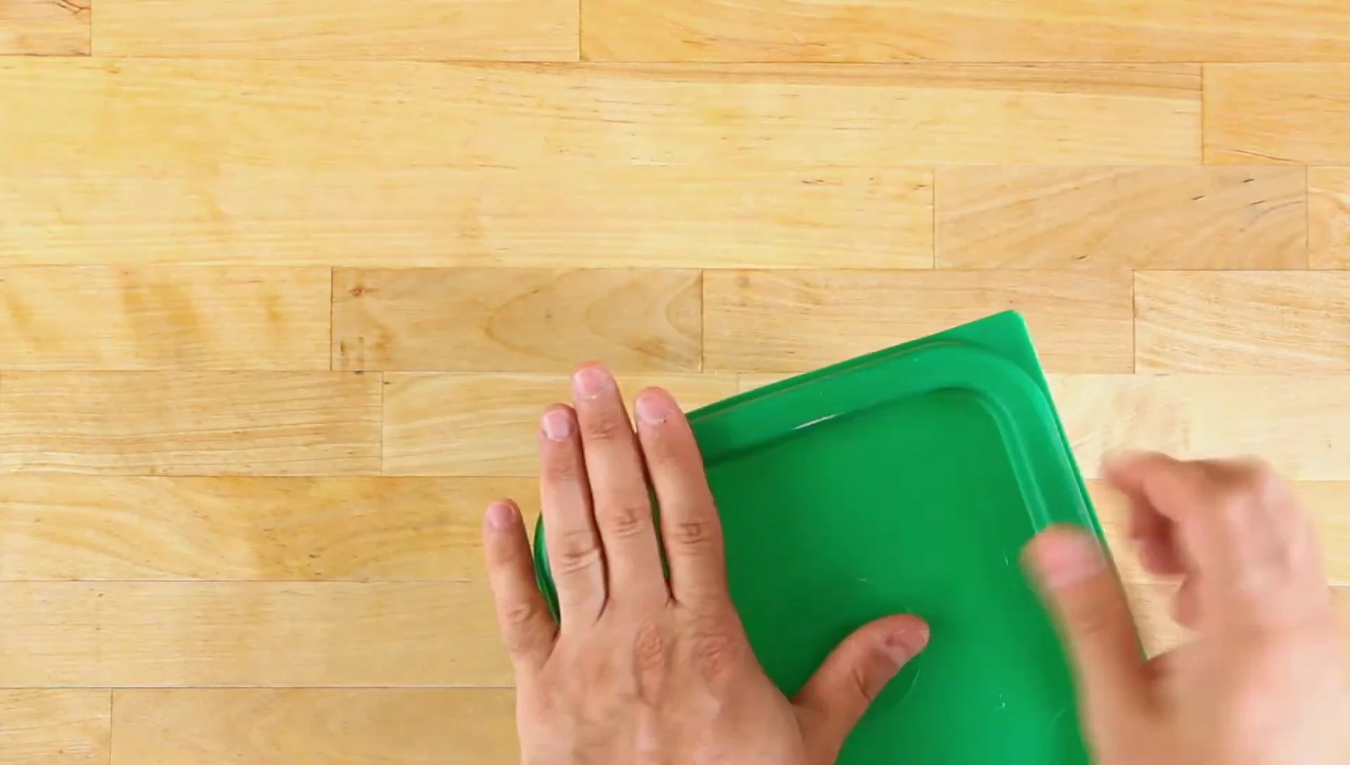 A person demonstrating the secure lid closure of a Cambro container.