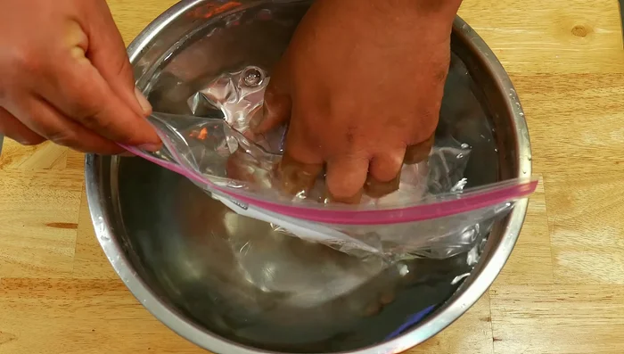 The water pressure will force the air out through the opening.