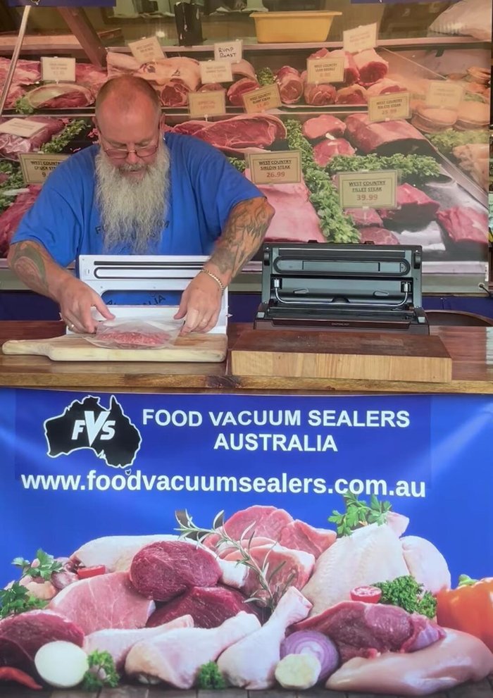 Gently push the bag opening into the vacuum chamber, ensuring a flat, crease-free placement.