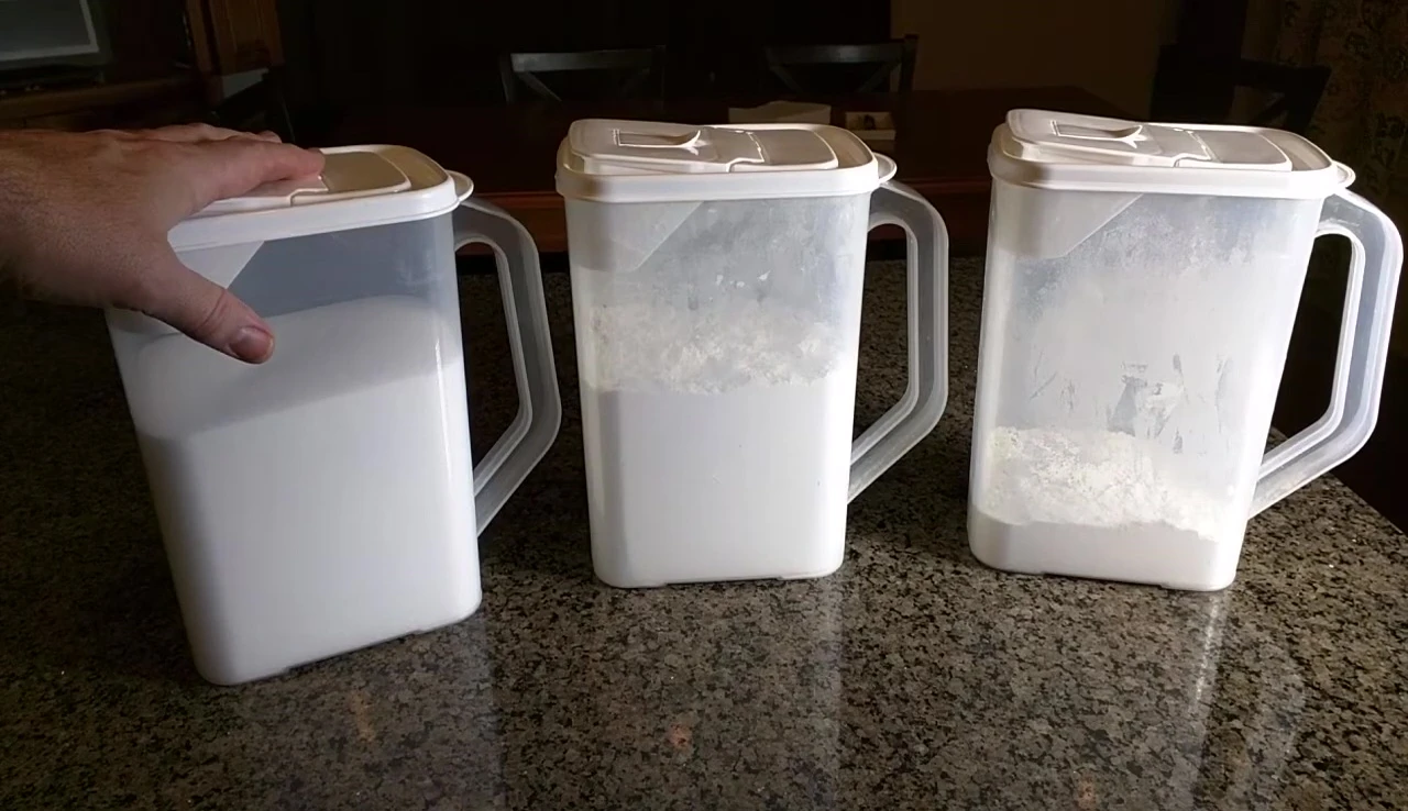 The reviewer holding one of the containers