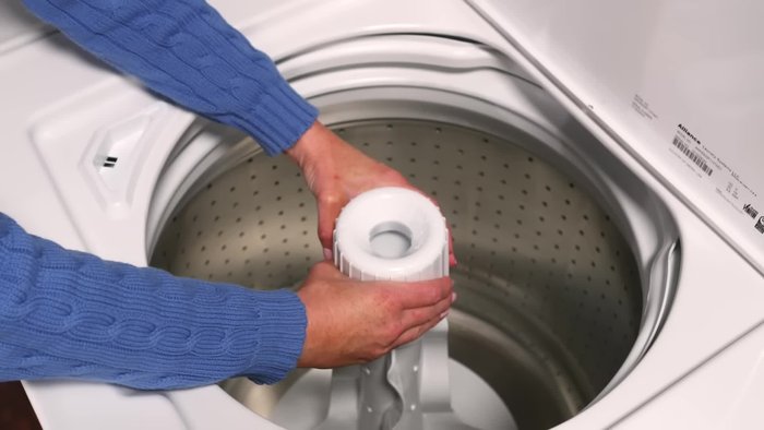 Separate the lower part of the dispenser by squeezing the bottom of the housing and pulling on the cup at a slight angle.