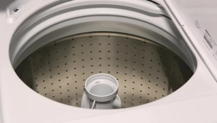 Push the dispenser housing downward onto the agitator until it snaps into place.