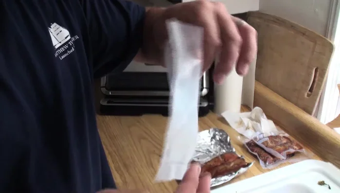 Wipe off any oil from the fish on the bag's edge with a paper towel to ensure a better seal.