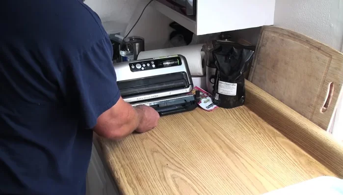 Pull out about 6-7 inches of bag material, fold it in half, and cut along the crease to create two bags.