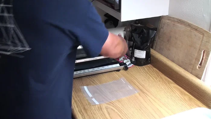 Pull out about 6-7 inches of bag material, fold it in half, and cut along the crease to create two bags.