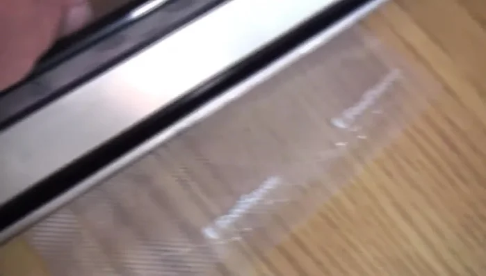 Close the FoodSaver and seal the bag. The red light indicates when sealing is complete.