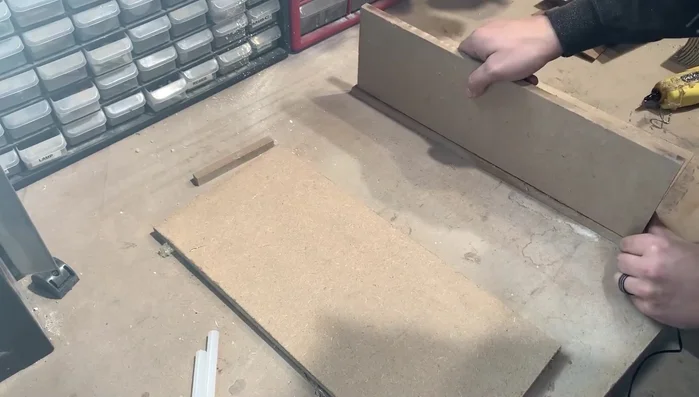 Attach Remaining Side and Top: Secure the remaining side piece and the top. Use hot glue for temporary hold and finishing nails for permanent securing.