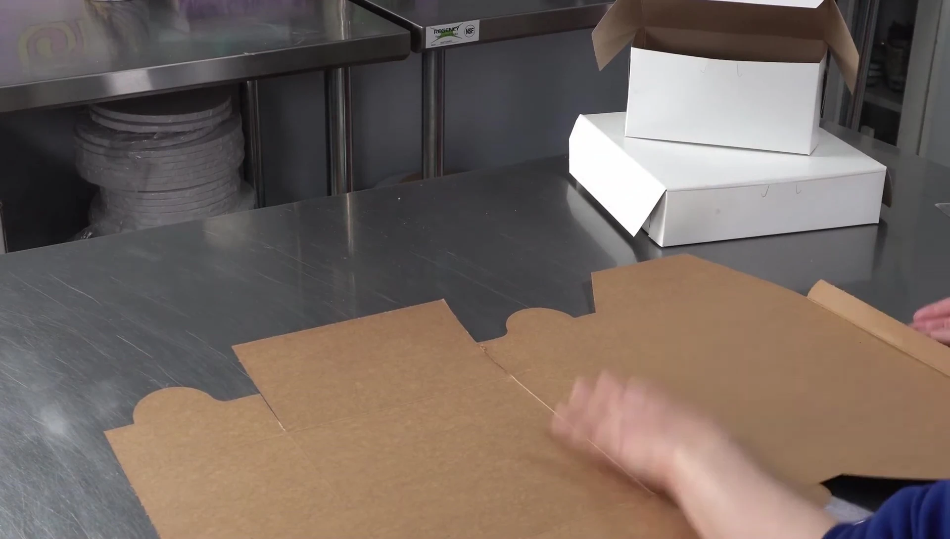 Demonstration of properly folding and releasing stuck flaps before assembling