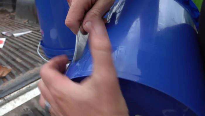 Cut the dispensing hole: Carefully cut out the marked area, ensuring it's slightly smaller than initially planned to create a snug fit for the food dispenser.