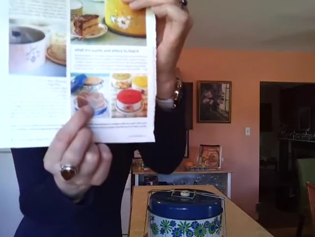 The speaker showing a blue and green cake carrier she owns.