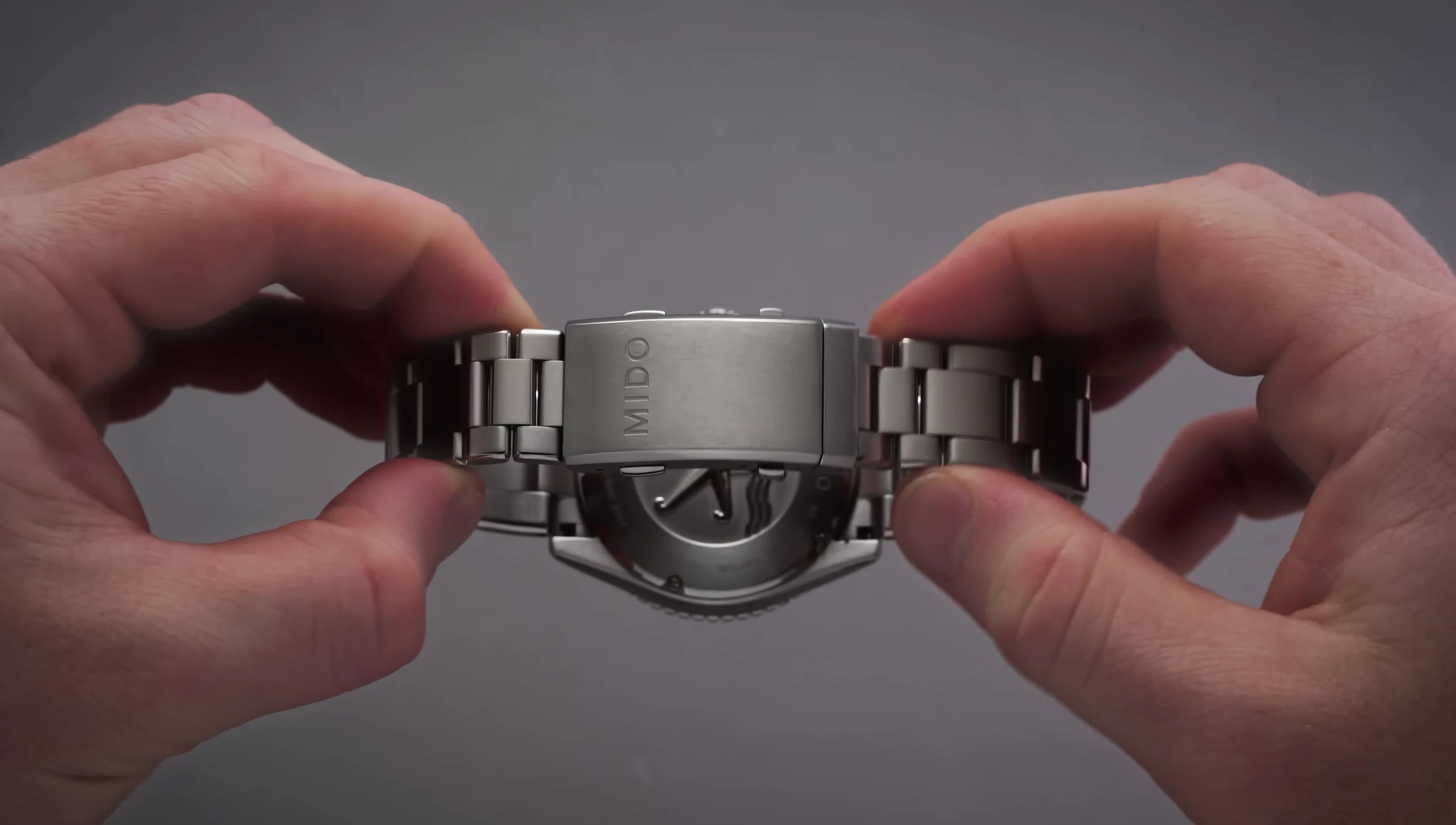 Detailed view of the clasp with dual push-button mechanism
