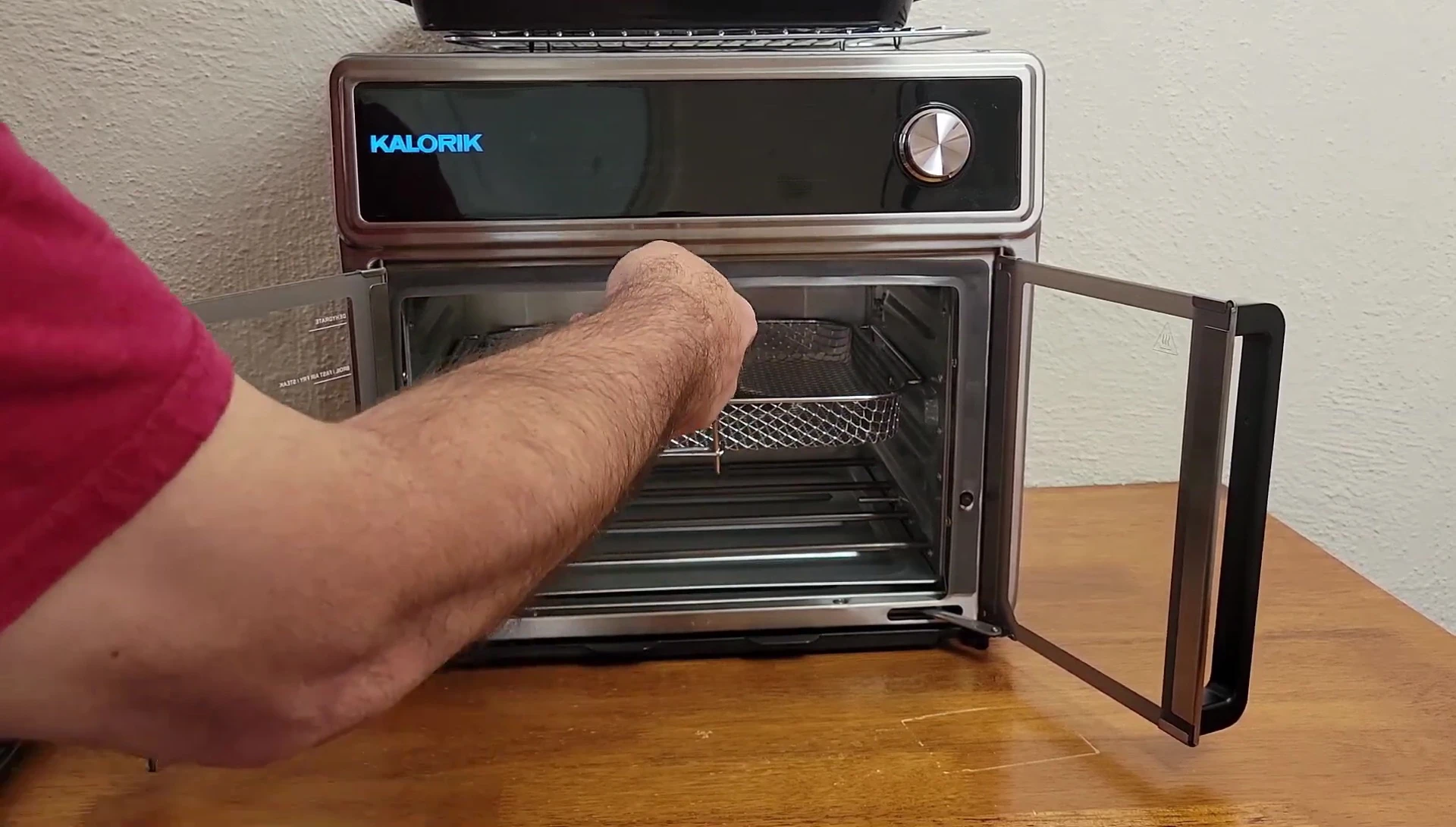 The basket removal tool being used to remove the air fryer basket.