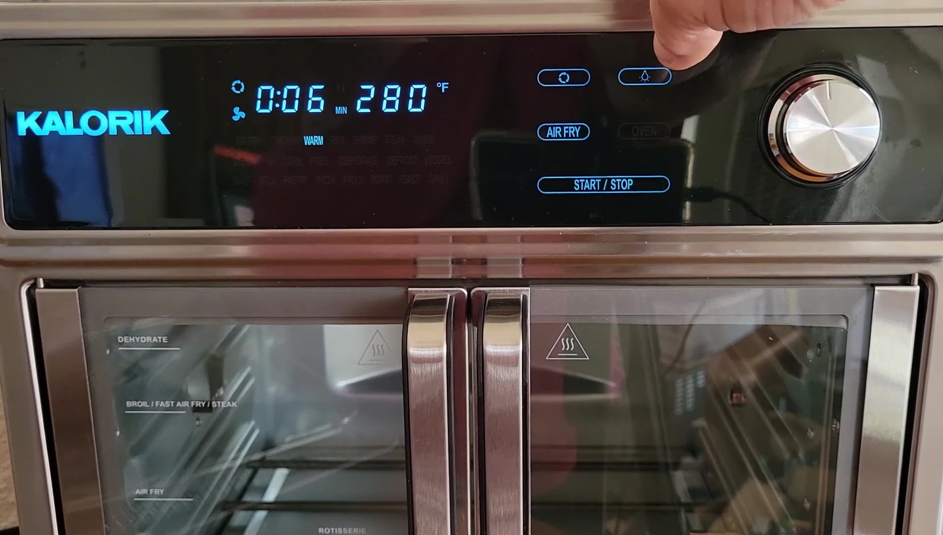 The rotisserie button and icon on the control panel highlighted.