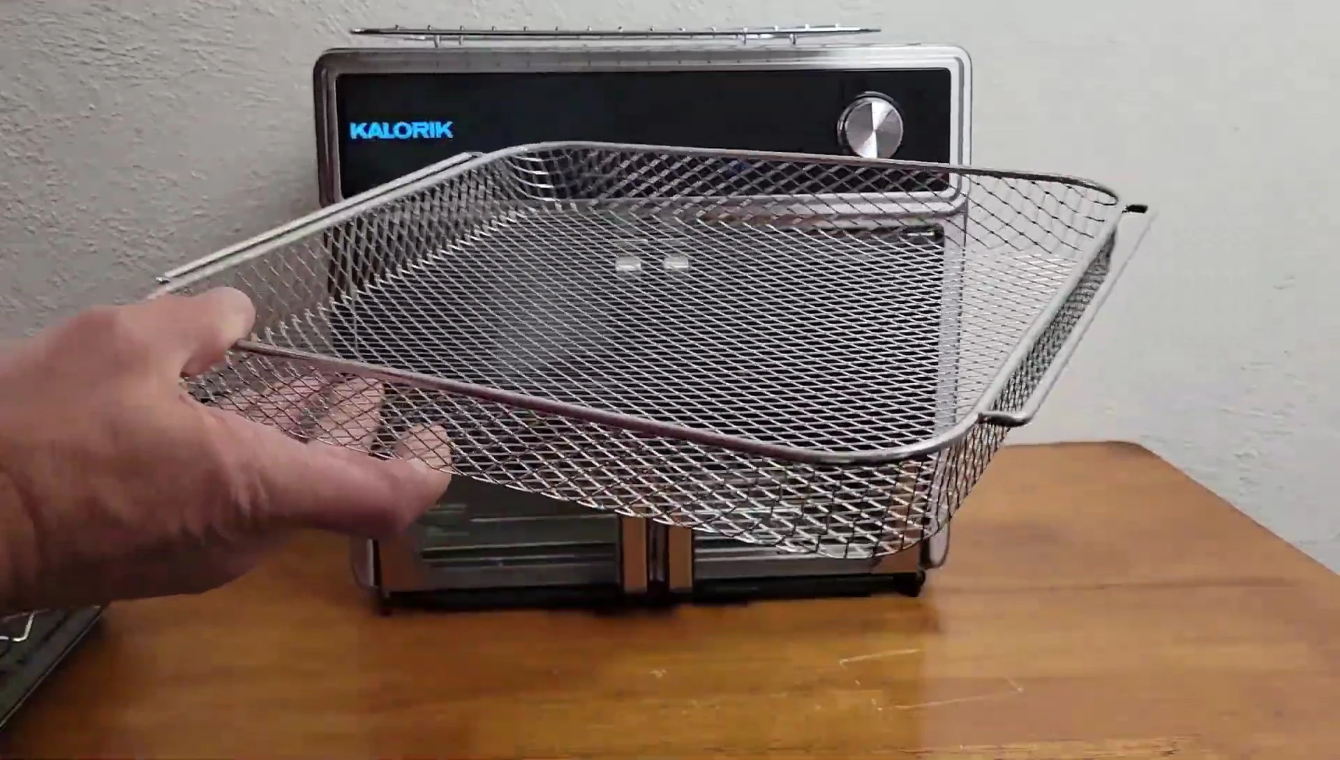The air fryer basket with the side rails shown.