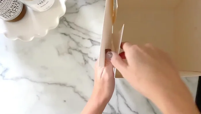 Assemble the base: Insert the tabs of two sides *inside* the box, and the tabs of the other two sides *outside* the box.