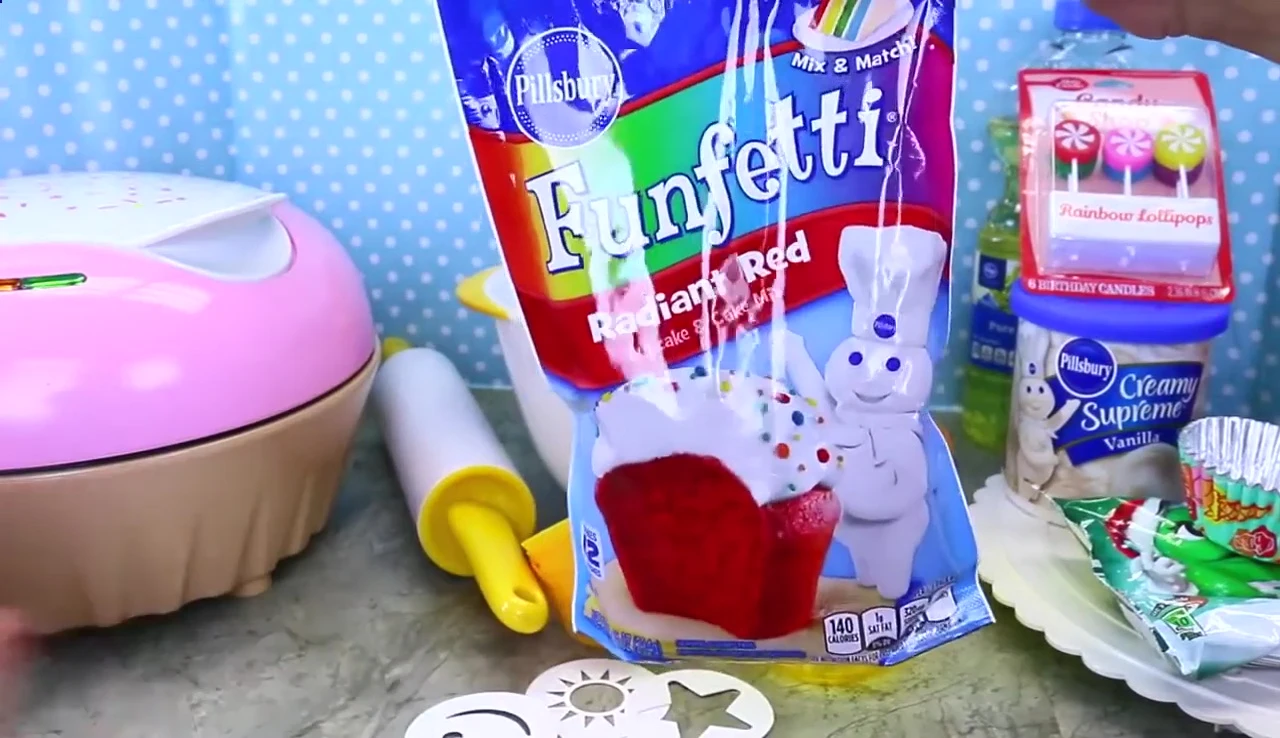 The red food coloring being added to the batter.